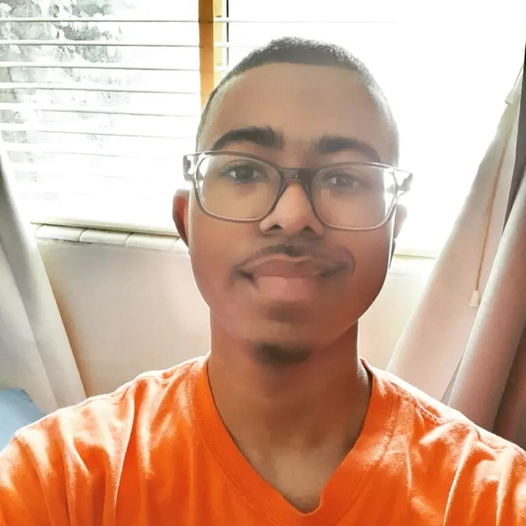 Photo of self posing in front of window. For Micah Jackson website