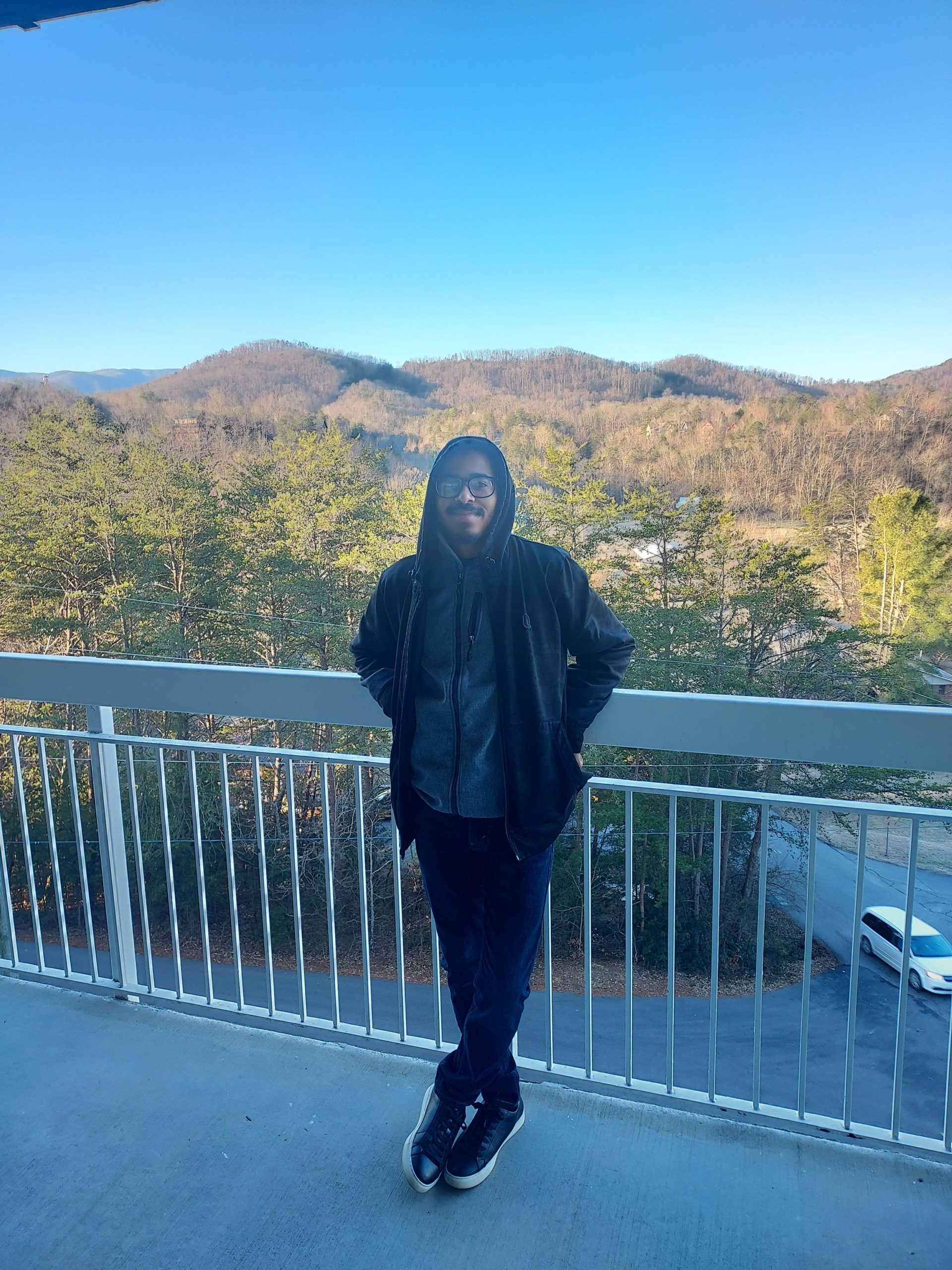 Photo of self posing by balcony in Gatlinburg. For Micah Jackson website